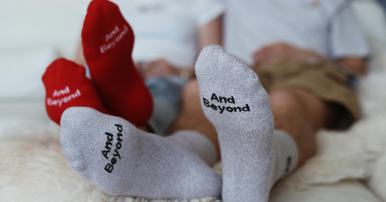 Putting our feet up in red and grey And Beyond socks